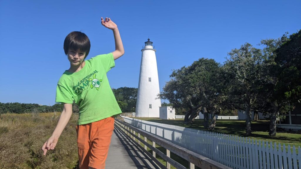 James balances on a rail near the Ocracoke Lighthouse.